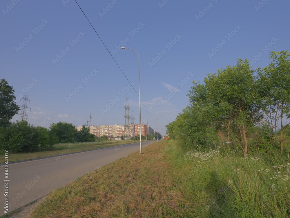 electric power lines over green landscape and road