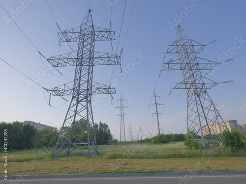 electric power lines over green landscape and road