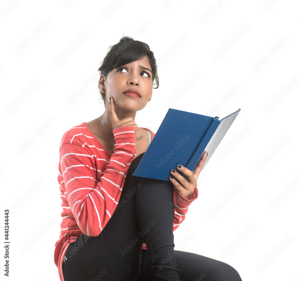 Pretty young girl holding book and posing on white background Pretty young girl holding book and posing on white background