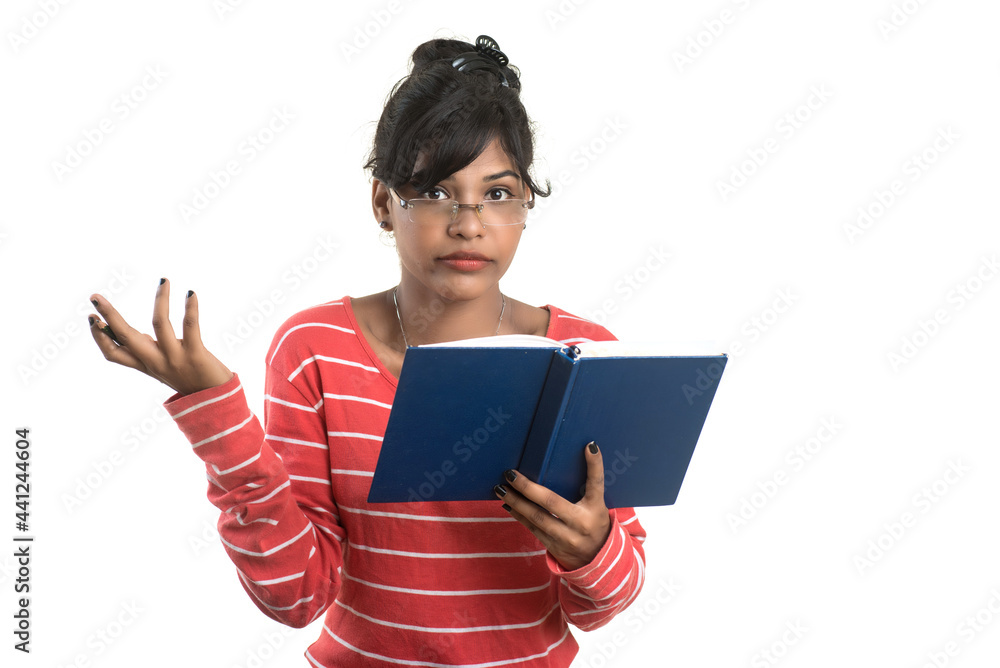 Pretty young girl holding book and posing on white background Pretty young girl holding book and posing on white background