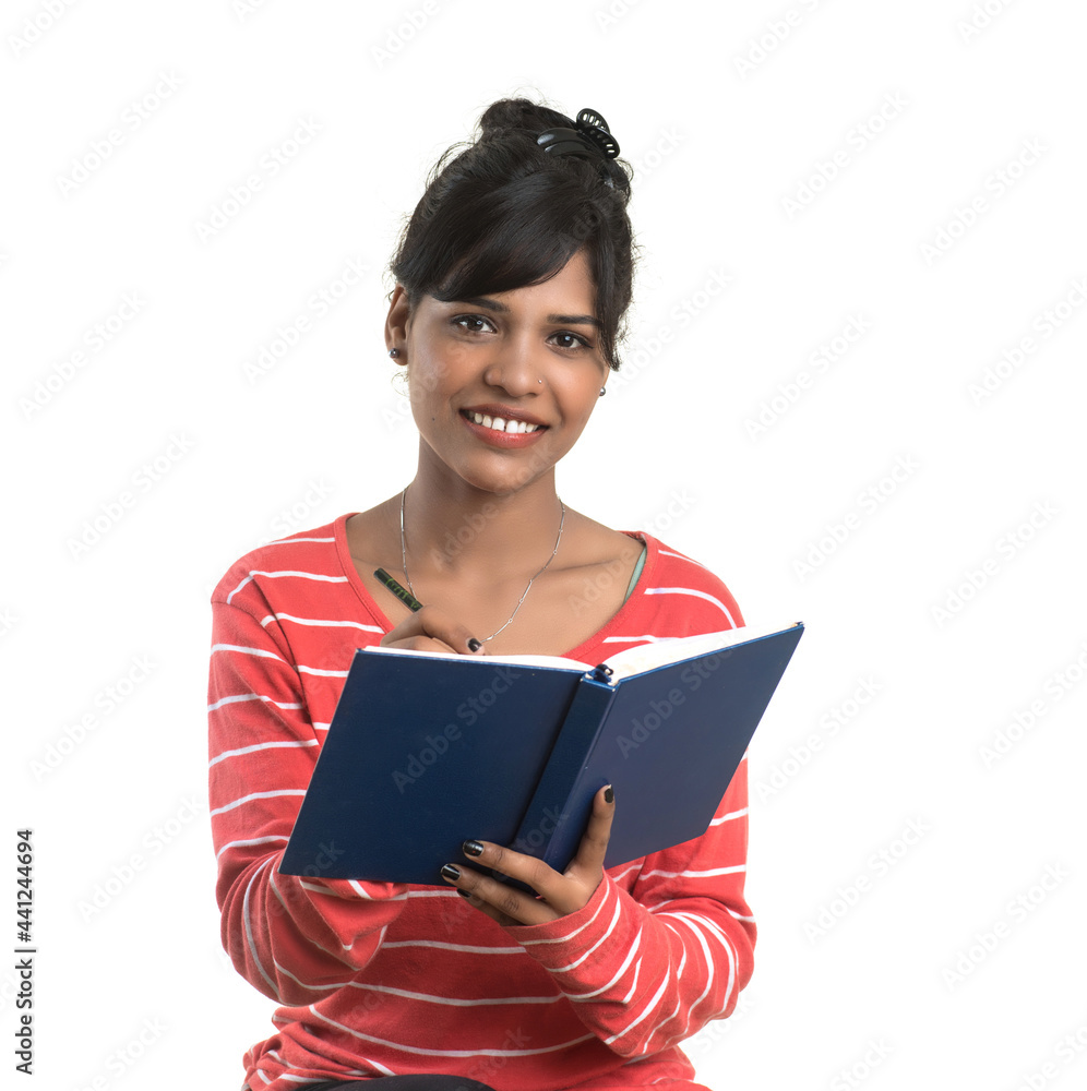Pretty young girl holding book and posing on white background Pretty young girl holding book and posing on white background