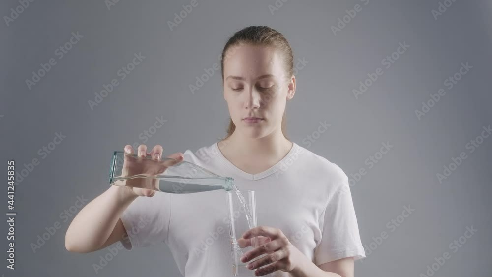 Shooting of woman pouring mineral water in glass Shooting of woman pouring mineral water in glass
