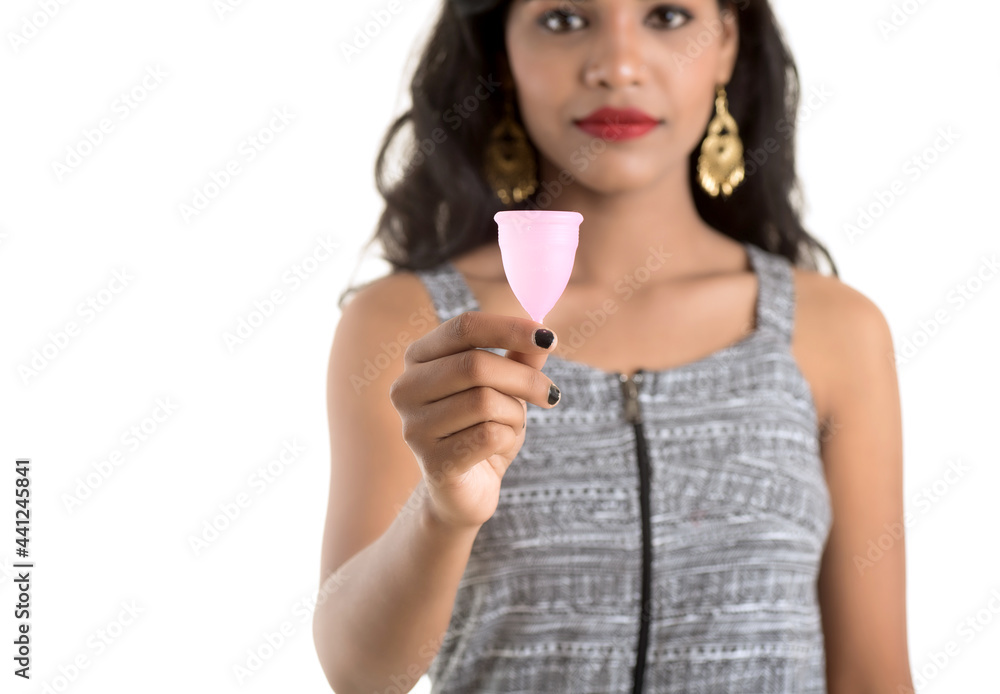 Close-up of young girl hands holding menstrual cup, Gynaecology concept, Showing thumbs up approving the use of the menstrual cup Close-up of young girl hands holding menstrual cup, Gynaecology concept, Showing thumbs up approving the use of the menstrual cup