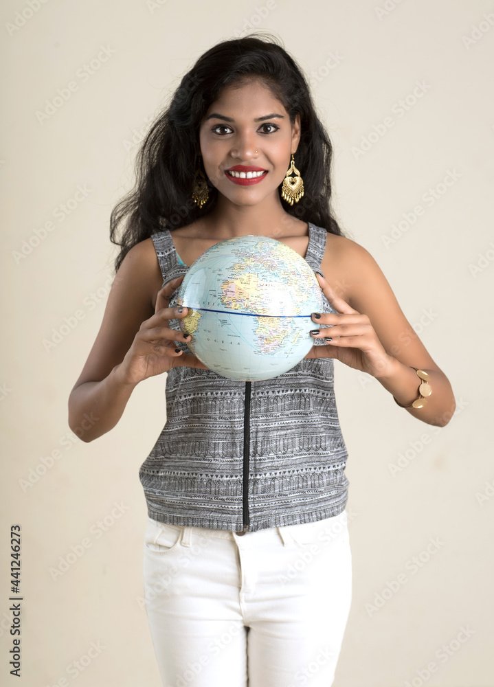 Portrait of young Girl holding and posing with a world globe. Portrait of young Girl holding and posing with a world globe.