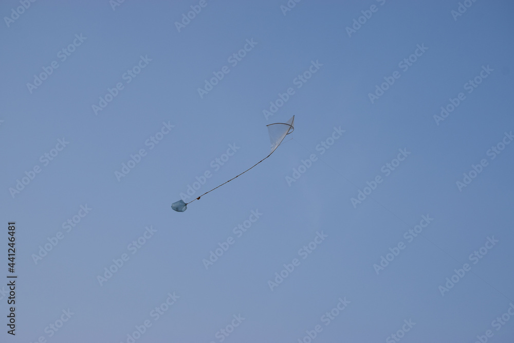 Asian Pakistan hand made kite in sky blue color clean weather Asian Pakistan hand made kite in sky blue color clean weather