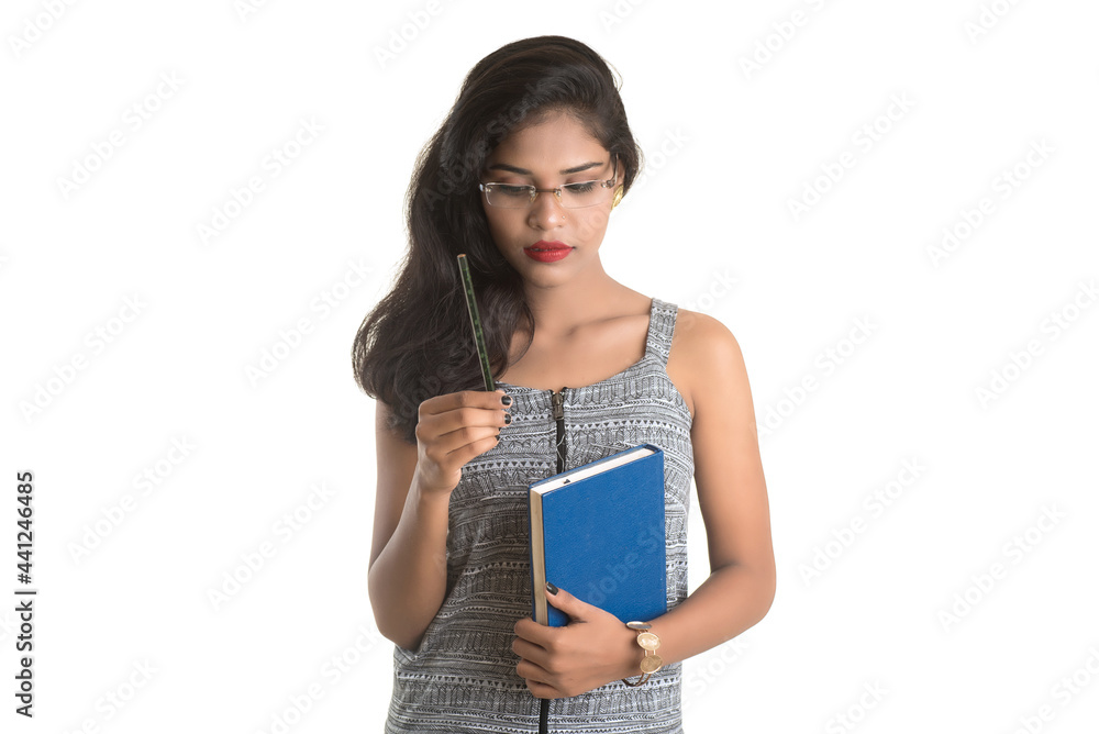 Pretty young girl holding book and posing on white background Pretty young girl holding book and posing on white background
