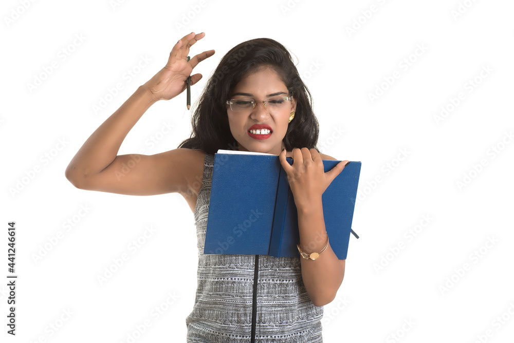 Pretty young girl holding book and posing on white background Pretty young girl holding book and posing on white background