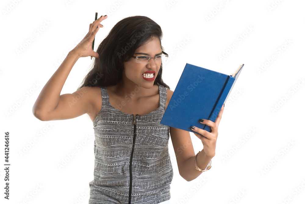 Pretty young girl holding book and posing on white background Pretty young girl holding book and posing on white background
