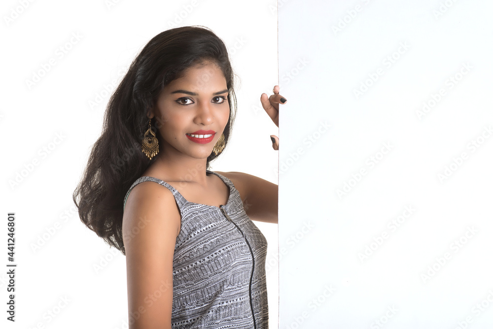 Beautiful young Girl holding white big signboard and posing Beautiful young Girl holding white big signboard and posing