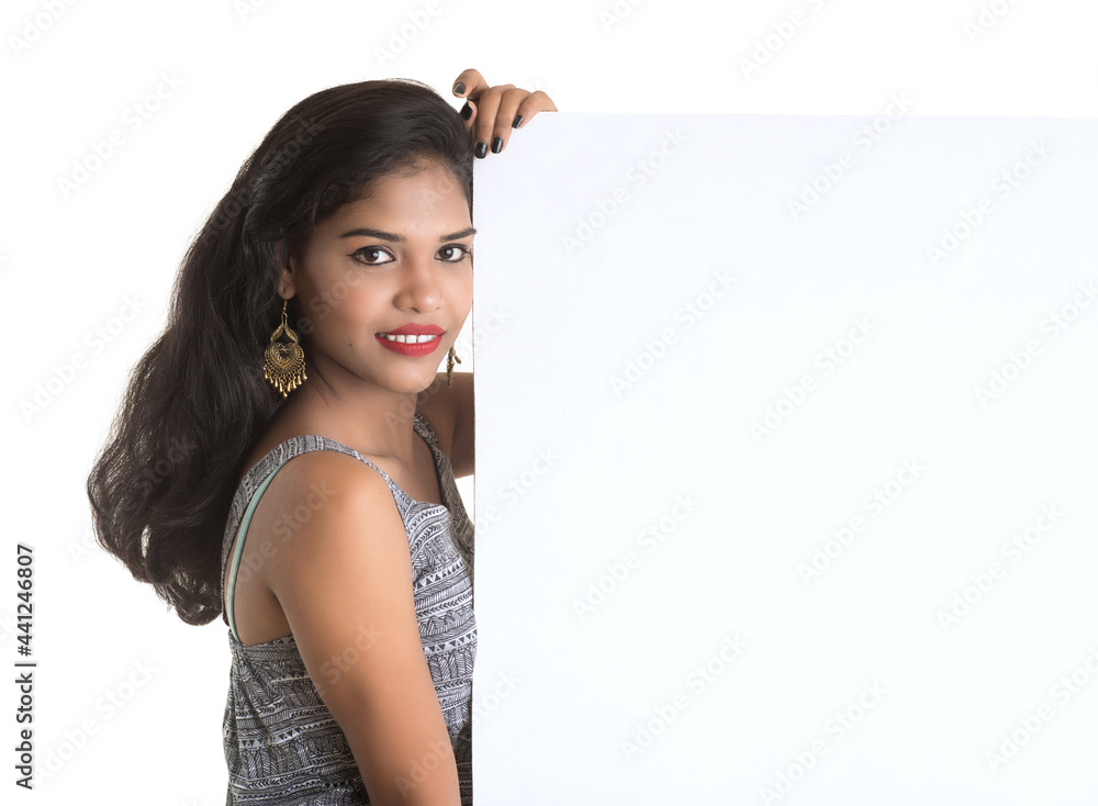 Beautiful young Girl holding white big signboard and posing Beautiful young Girl holding white big signboard and posing