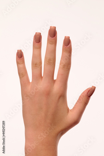 hand with nude manicure on white background