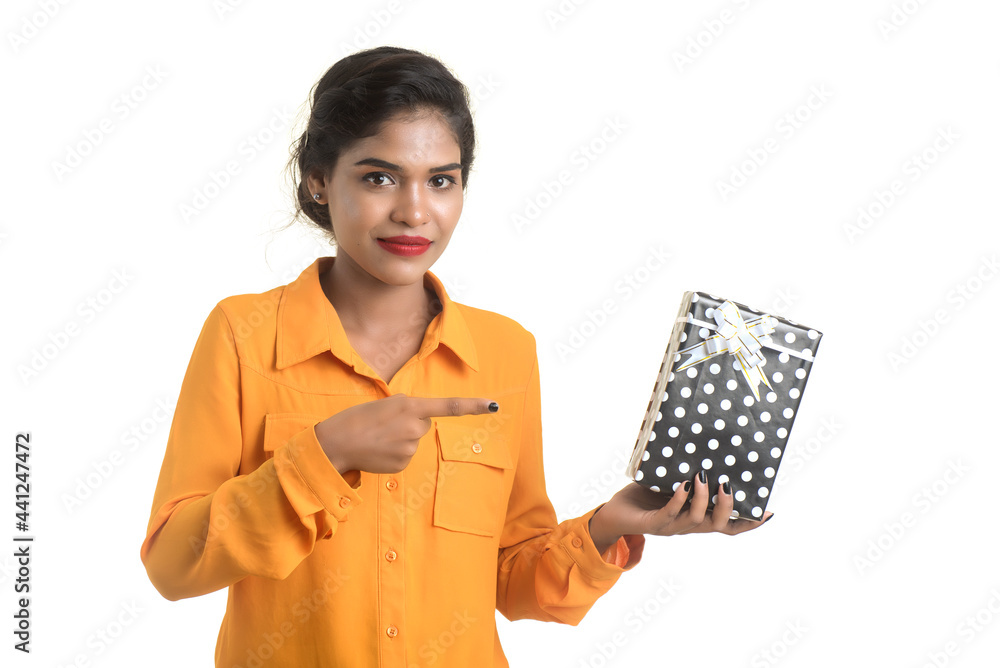 Portrait of young happy smiling Indian Girl holding gift boxes on a white background. Portrait of young happy smiling Indian Girl holding gift boxes on a white background.