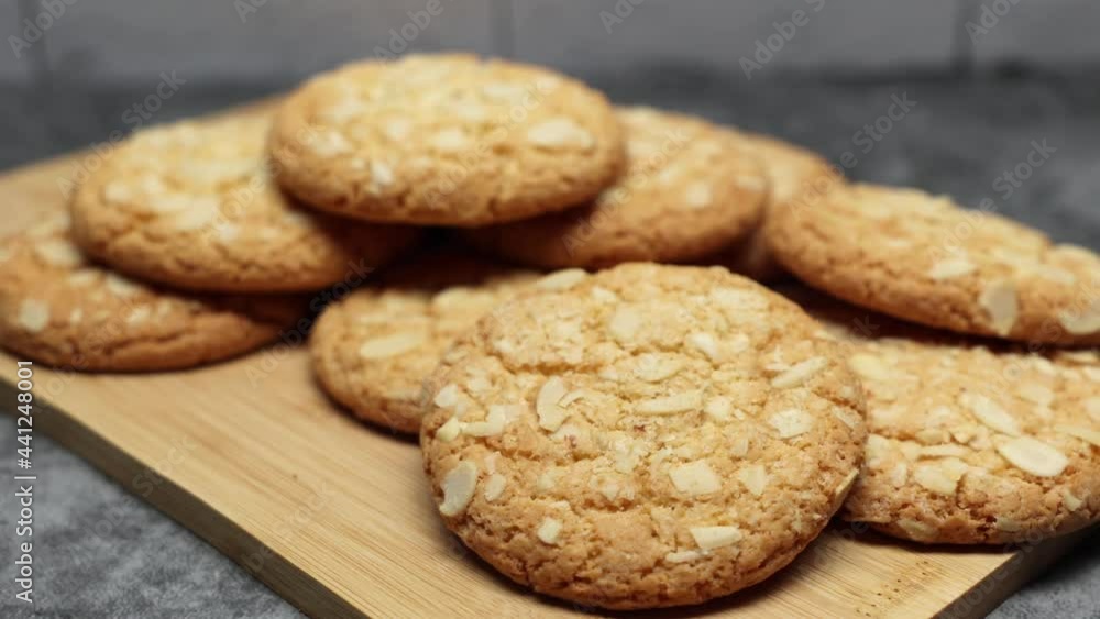 Brown Cookies With Almond Nut On Wooden Board On Gray Marble Background. Slider Shot. Brown Cookies With Almond Nut On Wooden Board On Gray Marble Background. Slider Shot.