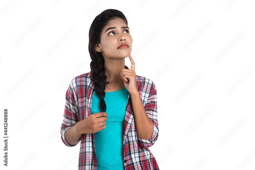 Indian girl thinking on a white background Indian girl thinking on a white background