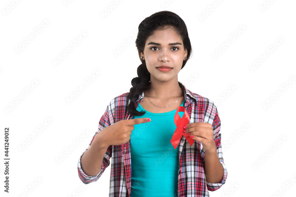 Young woman showing red ribbon HIV, AIDS awareness ribbon, healthcare and medicine concept Young woman showing red ribbon HIV, AIDS awareness ribbon, healthcare and medicine concept