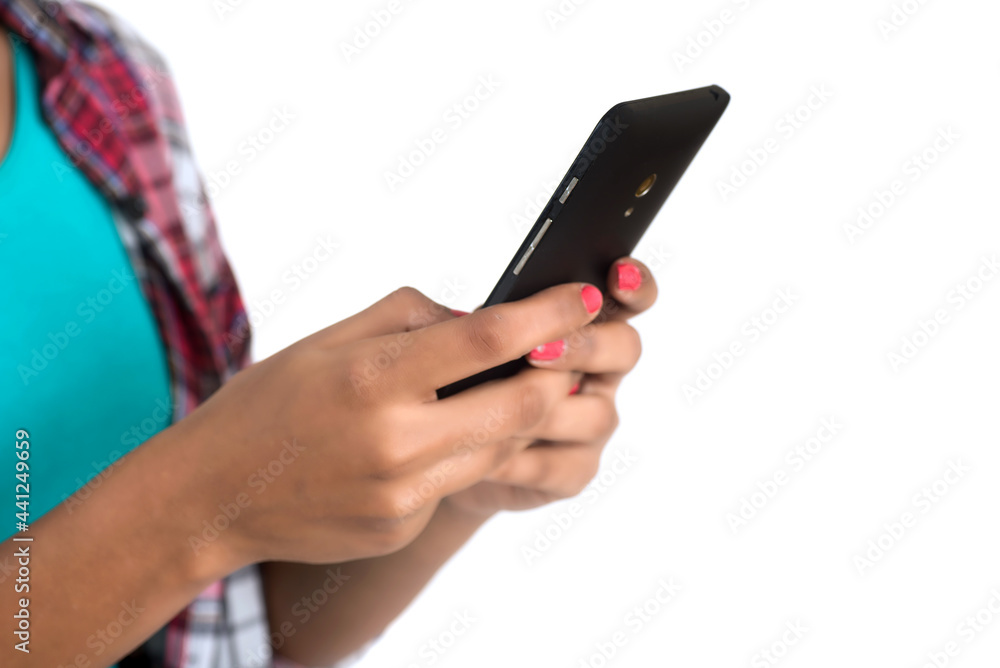 Young Indian girl using a mobile phone or smartphone isolated on a white background Young Indian girl using a mobile phone or smartphone isolated on a white background