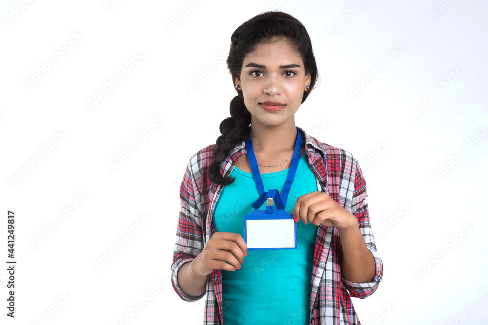 Young woman holding Identification white blank plastic id card. Young woman holding Identification white blank plastic id card.