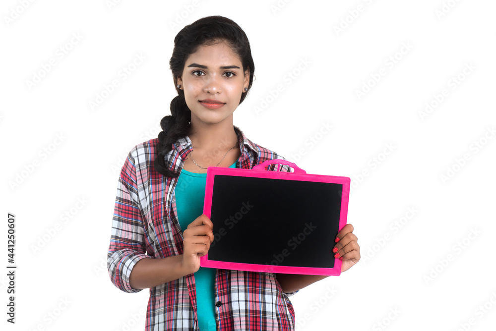 Beautiful young girl holding or posing with a chalkboard slate on a white background Beautiful young girl holding or posing with a chalkboard slate on a white background