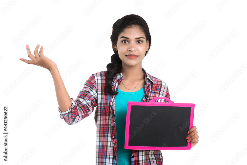 Beautiful young girl holding or posing with a chalkboard slate on a white background Beautiful young girl holding or posing with a chalkboard slate on a white background