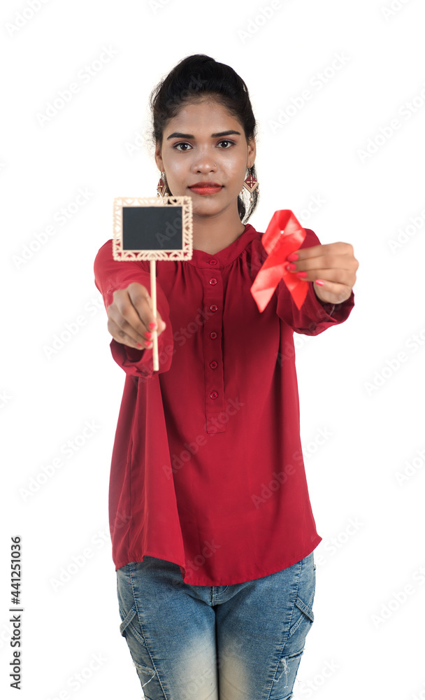 Young woman showing red ribbon HIV, AIDS awareness ribbon, healthcare and medicine concept Young woman showing red ribbon HIV, AIDS awareness ribbon, healthcare and medicine concept