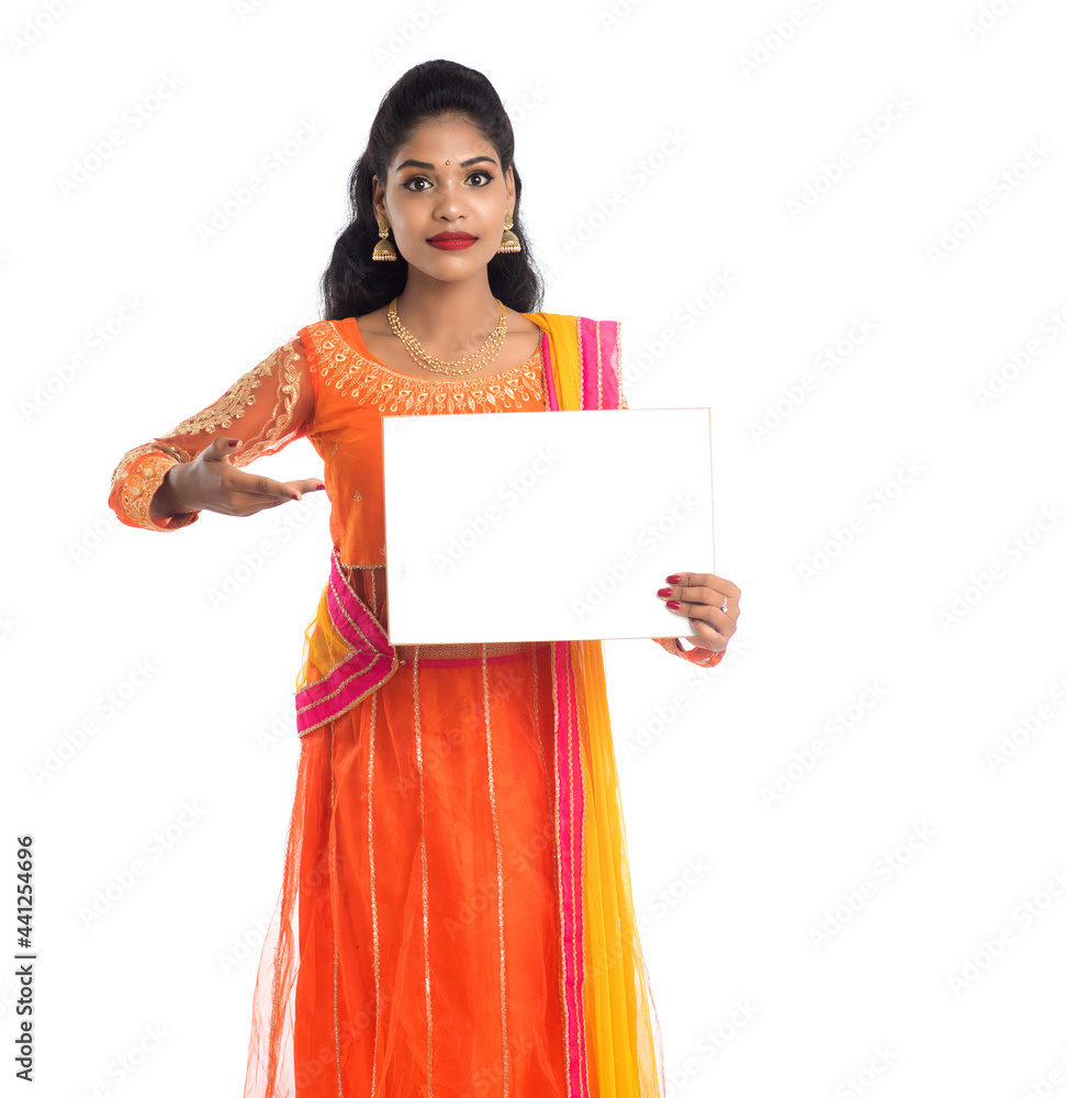 Traditional Girl holding and showing blank white sign board Traditional Girl holding and showing blank white sign board