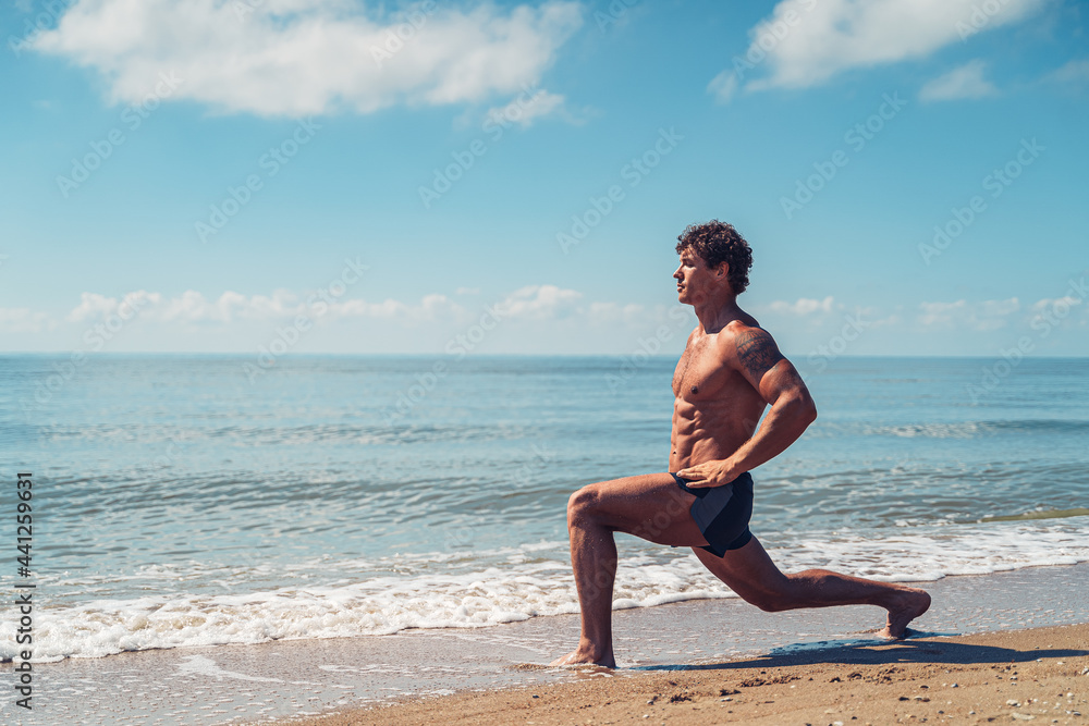 Muscular man doing exercise on beach. Body training Muscular man doing exercise on beach. Body training