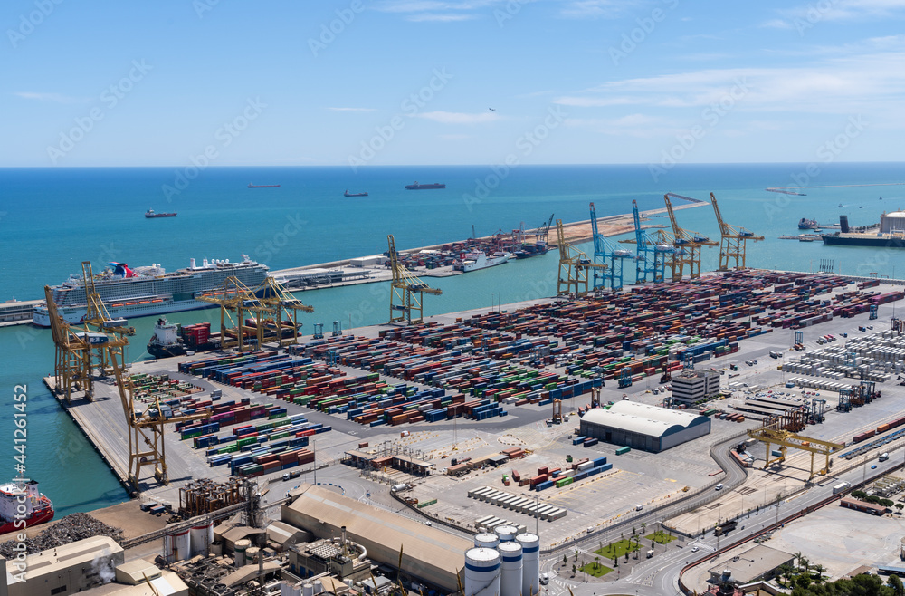 The port of Barcelona with cranes, ships and shipping containers