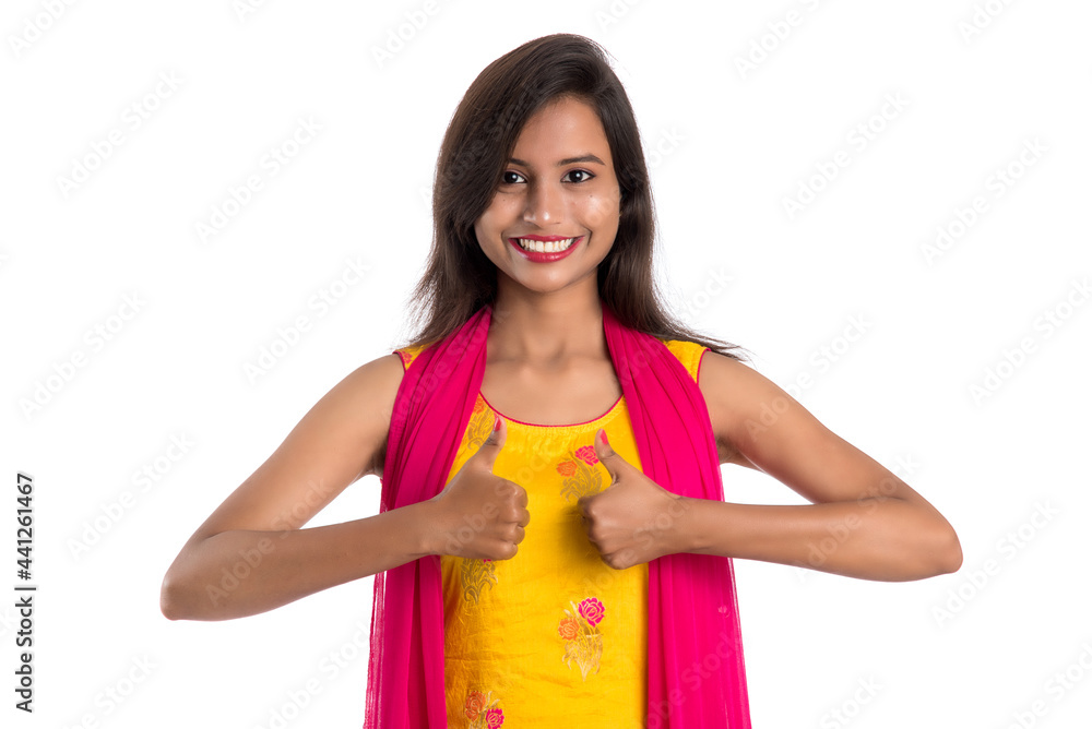 Smiling cheerful girl showing sign isolated on white background Smiling cheerful girl showing sign isolated on white background