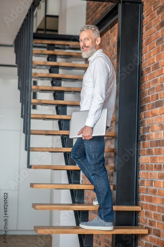 Wallpaper Mural Mature tall mid-aged man standing on the stairs Torontodigital.ca