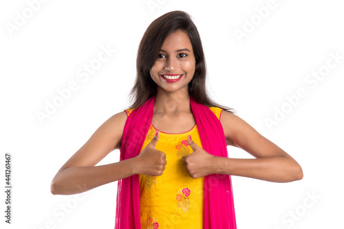 Smiling cheerful girl showing sign isolated on white background