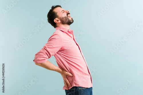 Attractive man having a lot of back pain photo