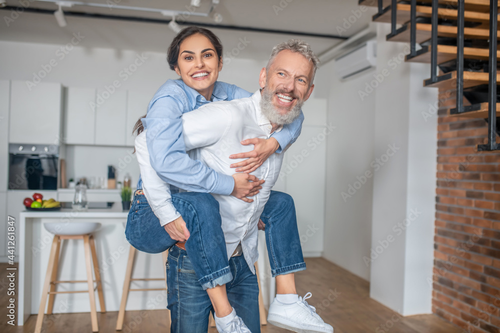 A happy couple having fun at home dancing and enjoying A happy couple having fun at home dancing and enjoying