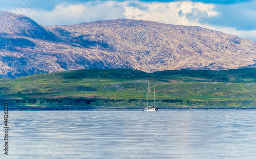 A view from a boat across the Firth of Lorn towards Lismore island near to Oban, Scotland on a summers day photo