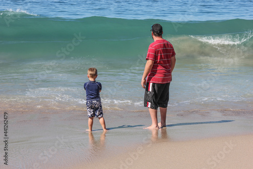 Father and son playing in the waves in Puerto Vallarta Mexico