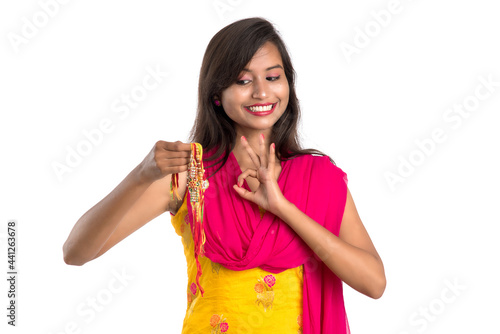 Beautiful Indian girl showing Rakhis on occasion of Raksha bandhan. Sister tie Rakhi as symbol of intense love for her brother.