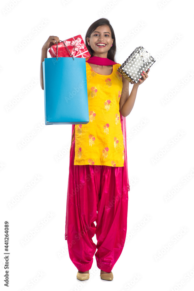 A beautiful woman posing with a shopping bag and gift Boxes on a white background. A beautiful woman posing with a shopping bag and gift Boxes on a white background.