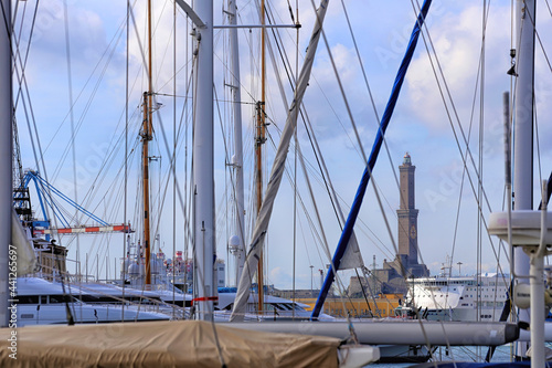 Genoa, Italy. Sailboats against the Genoa Lanterna lighthouse. View through the masts of sailboats docked at the dock in the area of the port "Porto Antico" © M.Scarselletta