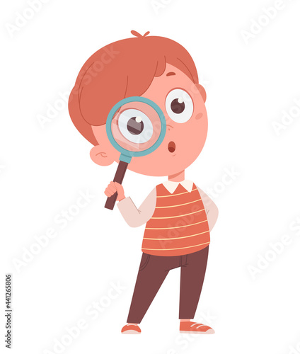 Cheerful schoolboy holding magnifier