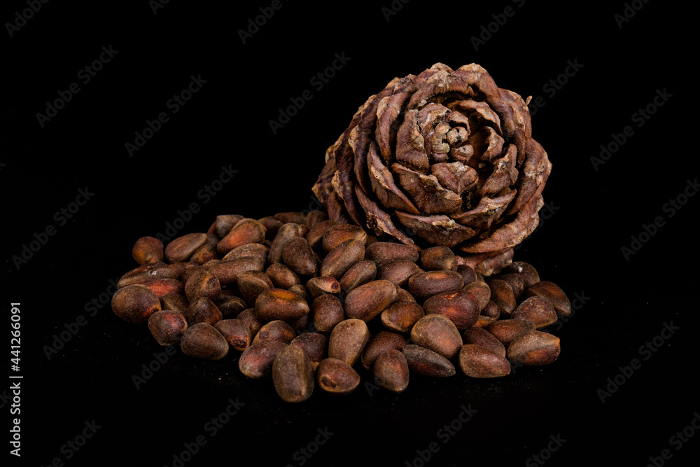 Pine nuts and ripe pine cones on a black background Pine nuts and ripe pine cones on a black background
