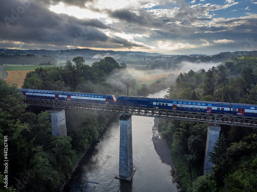 a train crossing a railway bridge over a river photo