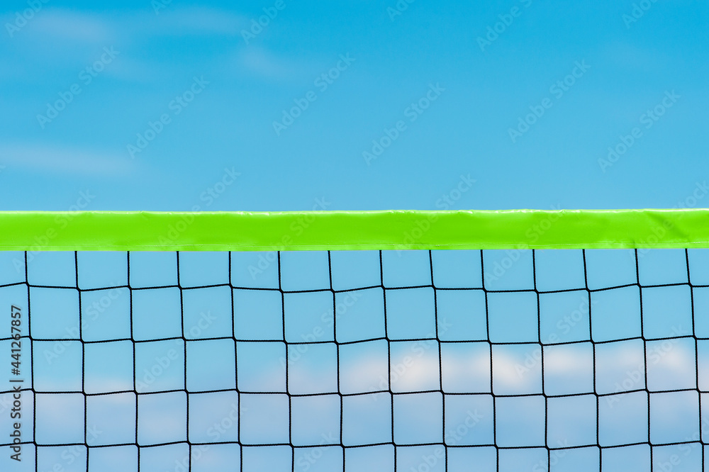 Beach volleyball and beach tennis net on the background of blue sky with clouds. Summer sport concept. Beach volleyball and beach tennis net on the background of blue sky with clouds. Summer sport concept.