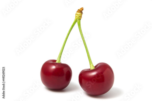 Two isolated red cherries on a white background.