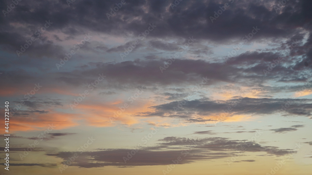 Fototapeta premium Dark, light clouds and blue sky at sunset