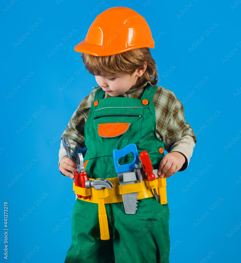 Little boy in builders uniform with tool belt. Tools for building. Kid repairman. Child game. Little boy in builders uniform with tool belt. Tools for building. Kid repairman. Child game.