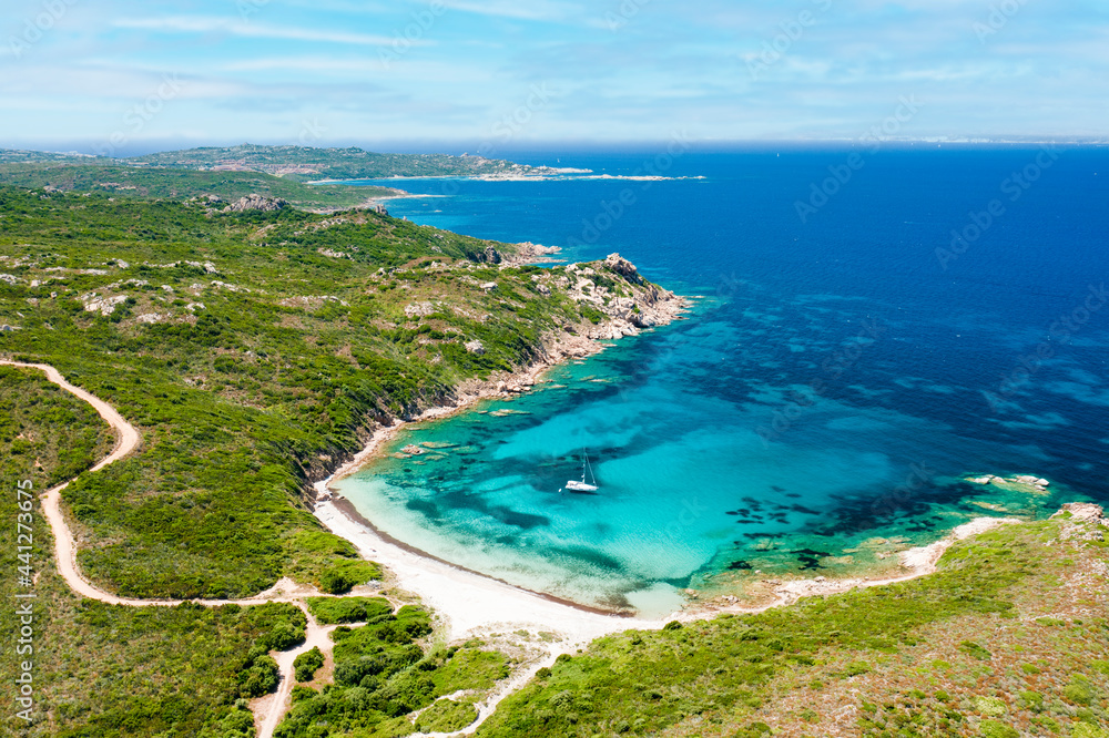 View from above, stunning aerial view of a wild beach bathed by a beautiful turquoise sea. Costa Smeralda, Sardinia, Italy.