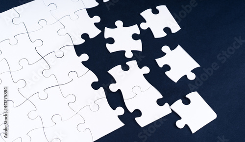 Top view on unfinished blank jigsaw puzzle photo