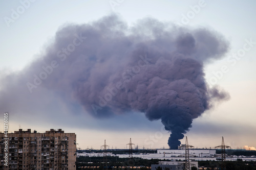 Black smoke from a large fire on the outskirts of the city