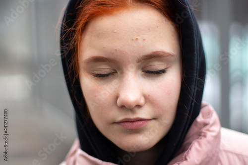 Portrait with eyes closed. The girl doesn't look at the camera.