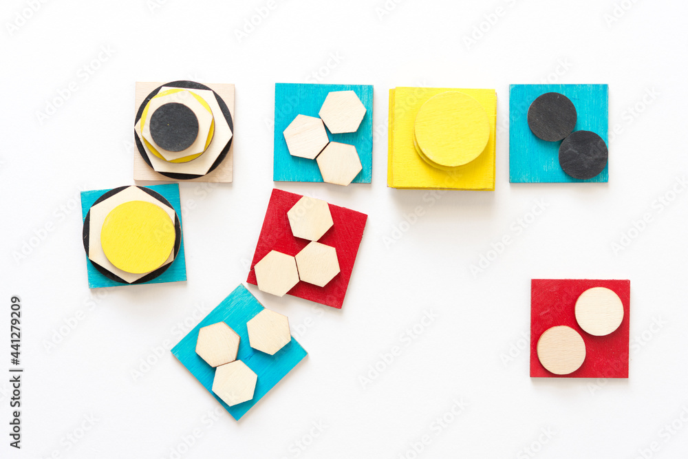 blue yellow and red squares layered with hexagonal wooden shapes isolated on white blue yellow and red squares layered with hexagonal wooden shapes isolated on white