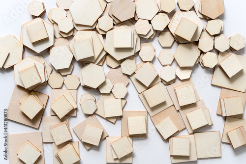 big pile of various sized wooden shapes in hexagonal and square form on white